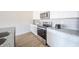 Kitchen features stainless steel appliances, granite countertops, white cabinets, and hardwood floors at 6204 Fairview Dr, McCordsville, IN 46055