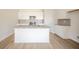 Bright kitchen featuring granite countertops, a kitchen island, white cabinets and stainless steel appliances at 6204 Fairview Dr, McCordsville, IN 46055