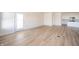 Light-filled open living area with wood-look flooring and sliding glass doors to outdoor space at 6204 Fairview Dr, McCordsville, IN 46055
