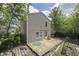 View of back of the home with wood deck and siding, surrounded by green trees at 6534 Redland Way, Indianapolis, IN 46217
