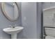 Cozy bathroom with blue walls and a pedestal sink at 6534 Redland Way, Indianapolis, IN 46217