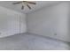 Simple bedroom with neutral carpeting, ceiling fan, and door to the hallway at 6534 Redland Way, Indianapolis, IN 46217