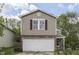 Charming two-story home featuring a front-facing two car garage and a well-manicured lawn at 6534 Redland Way, Indianapolis, IN 46217