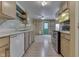 Open concept kitchen, featuring light wood cabinetry, leading into living room and front door at 6534 Redland Way, Indianapolis, IN 46217