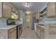Kitchen featuring light wood cabinets, modern appliances, and laminate flooring at 6534 Redland Way, Indianapolis, IN 46217