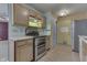 Kitchen featuring light wood cabinets and stainless steel appliances at 6534 Redland Way, Indianapolis, IN 46217