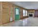 Living room features wood-paneled walls, fireplace, and natural light from the windows at 6534 Redland Way, Indianapolis, IN 46217