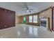 Spacious living room featuring a fireplace, a ceiling fan, wainscoting, and a bright green door at 6534 Redland Way, Indianapolis, IN 46217