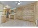 Bright living room with wood-paneled accent wall, connected to the kitchen with light wood cabinets at 6534 Redland Way, Indianapolis, IN 46217