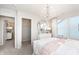 Inviting bedroom with soft carpet, stylish chandelier, and a serene atmosphere perfect for relaxation at 6801 Seabiscuit Rd, Whitestown, IN 46075