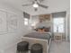 Cozy bedroom design with a ceiling fan, carpet floors, bedside tables, and sports-themed decor at 6801 Seabiscuit Rd, Whitestown, IN 46075