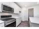 Modern kitchen featuring stainless steel appliances, white cabinets, and an adjacent dining area at 6801 Seabiscuit Rd, Whitestown, IN 46075