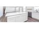 Open kitchen layout with stainless appliances, white cabinets and adjacent living space at 6801 Seabiscuit Rd, Whitestown, IN 46075