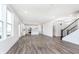 Bright, open living space with luxury vinyl plank flooring leading into a modern kitchen at 6801 Seabiscuit Rd, Whitestown, IN 46075
