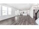 Bright living space with luxury vinyl plank flooring and an open view into the modern kitchen at 6801 Seabiscuit Rd, Whitestown, IN 46075