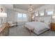 Serene main bedroom featuring a tray ceiling, carpet floors, a ceiling fan, and natural light at 6801 Seabiscuit Rd, Whitestown, IN 46075