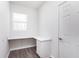 Bright home office featuring built-in desk, drawers, luxury vinyl plank flooring, and ample natural light at 6801 Seabiscuit Rd, Whitestown, IN 46075
