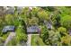Aerial view showcases home nestled among mature trees and greenery, highlighting its serene and private location at 7104 Combs Rd, Indianapolis, IN 46237