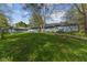 A home's serene backyard features lush greenery and a unique elevated boardwalk pathway at 7104 Combs Rd, Indianapolis, IN 46237