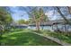 A backyard features mature trees and a boardwalk offering a tranquil outdoor experience at 7104 Combs Rd, Indianapolis, IN 46237