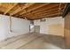 Unfinished basement area with painted cinderblock walls, a mirror, and wooden ceiling at 7104 Combs Rd, Indianapolis, IN 46237