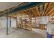 Unfinished basement area with wooden support beams and shelving for storage at 7104 Combs Rd, Indianapolis, IN 46237