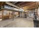 Unfinished basement space offers storage and utility, with exposed wood beams at 7104 Combs Rd, Indianapolis, IN 46237