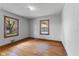 Bright bedroom featuring hardwood floors and two windows that provide natural light at 7104 Combs Rd, Indianapolis, IN 46237