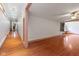 Open living space with hardwood floors and large windows offering natural light at 7104 Combs Rd, Indianapolis, IN 46237