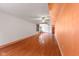 Spacious room featuring hardwood floors, a ceiling fan, and a small window with curtains at 7104 Combs Rd, Indianapolis, IN 46237