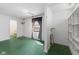 Room with shelving, green painted floors, and a window that brings in natural light at 7104 Combs Rd, Indianapolis, IN 46237