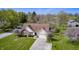 Aerial view of a well-maintained property with mature trees and a charming home with brick accents at 7114 Hickory Rd, Indianapolis, IN 46259