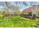 Spacious backyard with a deck, lush green grass, and privacy fence, ideal for outdoor enjoyment at 7114 Hickory Rd, Indianapolis, IN 46259