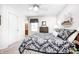 Cozy bedroom featuring carpet, ceiling fan, two windows, decor, lamps, and furniture at 7114 Hickory Rd, Indianapolis, IN 46259