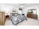 Bedroom with a ceiling fan, carpet, lamps, furniture, and decor for comfort at 7114 Hickory Rd, Indianapolis, IN 46259