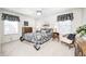 Comfortable bedroom with a ceiling fan, carpet, two windows, lamps, and matching furniture at 7114 Hickory Rd, Indianapolis, IN 46259