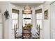 Bright breakfast nook featuring a table, chairs, three windows, and a pendant light to make the room cozy at 7114 Hickory Rd, Indianapolis, IN 46259
