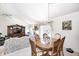 Open-concept dining area with a chandelier, wood table, and seamless flow to the living space at 7114 Hickory Rd, Indianapolis, IN 46259