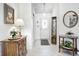 Bright foyer featuring neutral tile, a decorative mirror, and stylish entryway decor at 7114 Hickory Rd, Indianapolis, IN 46259