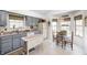Cozy kitchen featuring blue cabinets, eat-in breakfast nook and natural light from multiple windows at 7114 Hickory Rd, Indianapolis, IN 46259