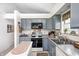 Well-equipped kitchen with gray cabinets, stainless appliances, and an island that provides additional counter space at 7114 Hickory Rd, Indianapolis, IN 46259