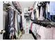 Walk-in closet with multiple rows of hanging clothes to maximize storage space at 7114 Hickory Rd, Indianapolis, IN 46259