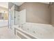 Bright bathroom featuring a luxurious soaking tub with a clear glass shower at 720 Bucksport Ln, Westfield, IN 46074