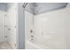Bright white tiled bath and shower combination with tile walls at 720 Bucksport Ln, Westfield, IN 46074
