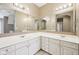 Bathroom with double sinks, white cabinetry, and an oversized mirror at 720 Bucksport Ln, Westfield, IN 46074