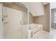 Bathroom with a soaking tub, glass enclosed shower and a large window at 720 Bucksport Ln, Westfield, IN 46074
