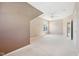 Bright, carpeted bedroom with a ceiling fan, window, and an open doorway to another room at 720 Bucksport Ln, Westfield, IN 46074