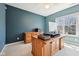 Office space with ceiling fan, natural light, and a wooden desk and cabinet, carpet and painted blue walls at 720 Bucksport Ln, Westfield, IN 46074