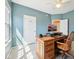 Inviting office featuring natural light, a wooden desk, and a comfortable chair, carpet and painted blue walls at 720 Bucksport Ln, Westfield, IN 46074