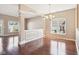 Open dining room with hardwood floors, chandelier, and a view of the living area at 720 Bucksport Ln, Westfield, IN 46074